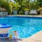 Clear swimming pool with floating chlorine tablet dispenser and water test kit
