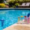 Clear swimming pool with thermometer and chlorine test kit on a sunny day