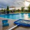 Clear backyard swimming pool after heavy rain with test kit and skimmer net
