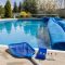 Backyard pool opening with cover, skimmer net, and water test kit
