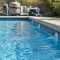 Clear pool water with return jets rippling the surface