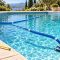 Suction pool cleaner hose stretched across a swimming pool for hose length troubleshooting
