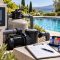 Pool automation controller, pump equipment and vacation checklist beside a clear backyard swimming pool