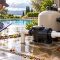 Homeowner inspecting wet pool equipment pad for leaks after heavy rain