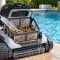 Robotic pool cleaner filter basket being rinsed after a cleaning cycle beside a backyard pool
